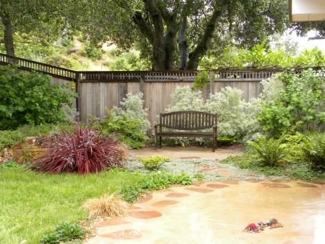 The bench sits on a decomposed granite patio which transitioned from the concrete patio in front